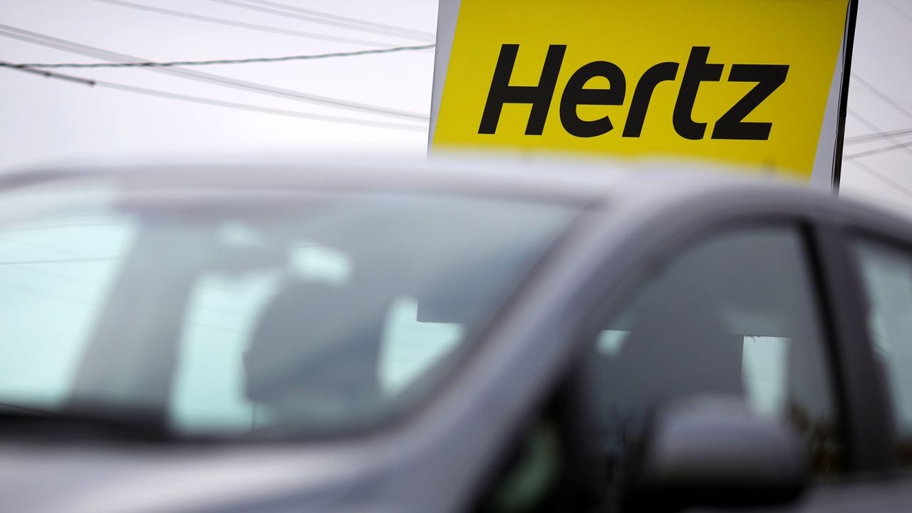 Signage is displayed outside of a Hertz Global Holdings Inc. rental car and sales location in Louisville, Kentucky, U.S., on Friday, Nov. 6, 2015. 