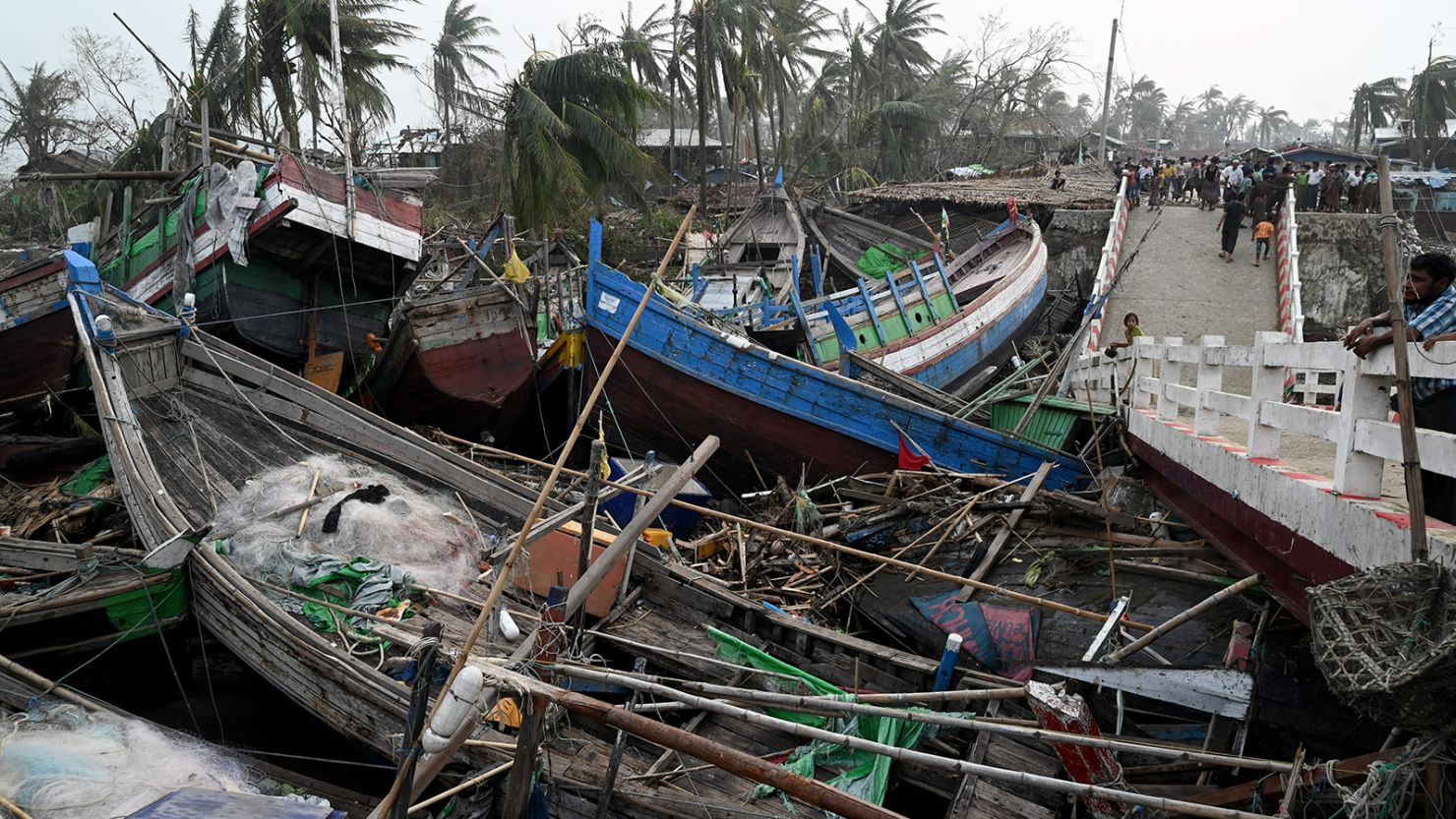 Broken boats are piled up next to a broken bridge in Sittwe, in Myanmar's Rakhine state, on May 15, 2023, after Cyclone Mocha made a landfall. 