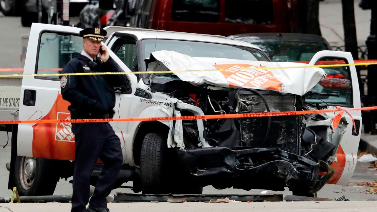 A damaged Home Depot truck remains on the scene after the driver mowed down people on a riverfront bike path in New York.