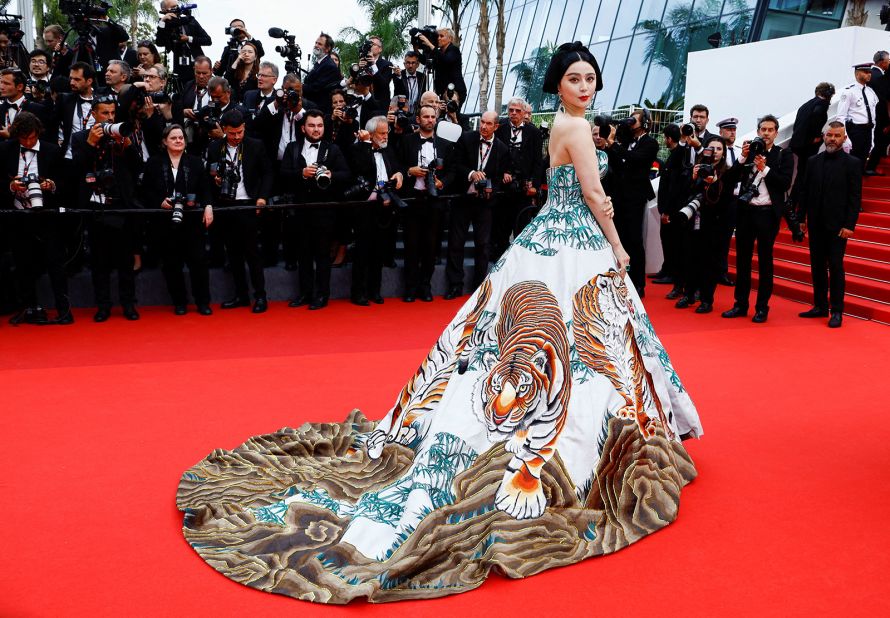 Chinese actor Fan Bingbing, while attending the "Jeanne du Barry" premiere, wore an ornate, painterly strapless Christopher Bu gown decorated with bamboo and tigers.