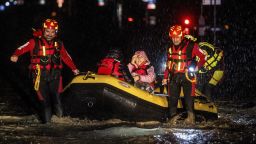 Firemen and civil protection rescuers evacuate a woman with an inflatable boat in Forli on May 17, 2023 after heavy rains have caused major floodings in central Italy, where trains were stopped and schools were closed in many towns while people were asked to leave the ground floors of their homes and to avoid going out. (Photo by AFP) (Photo by -/AFP via Getty Images)