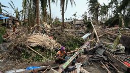 A woman sits in her destroyed house at Basara refugee camp in Sittwe on May 16, 2023, after cyclone Mocha made a landfall. The death toll in cyclone-hit Myanmar's Rakhine state rose to at least 41 on May 16, 2023, local leaders told AFP. 