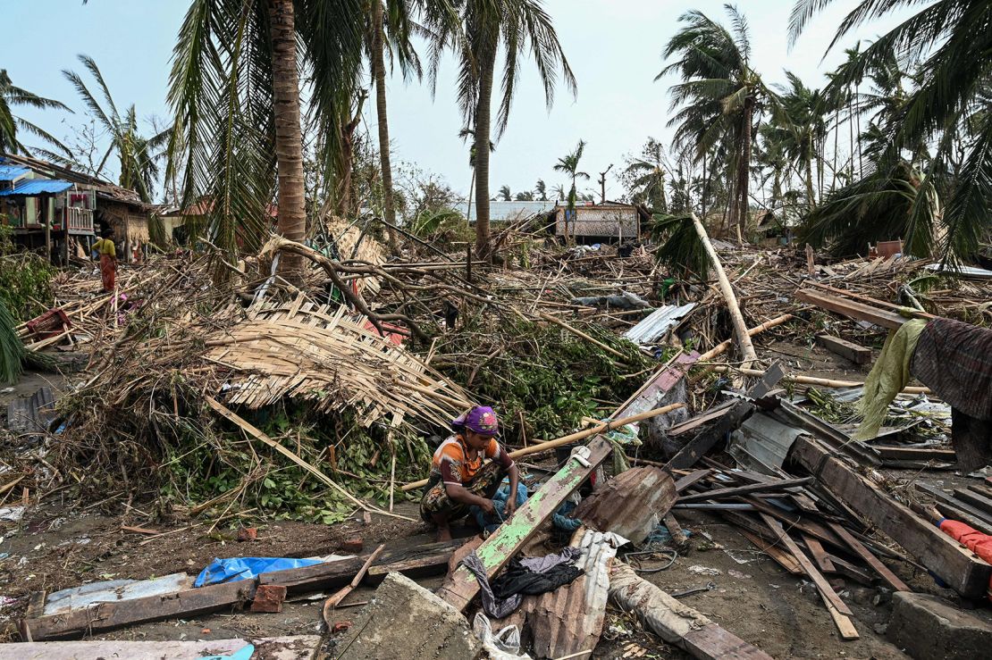A woman sits in her destroyed house at Basara refugee camp in Sittwe on May 16, after Cyclone Mocha made landfall.
