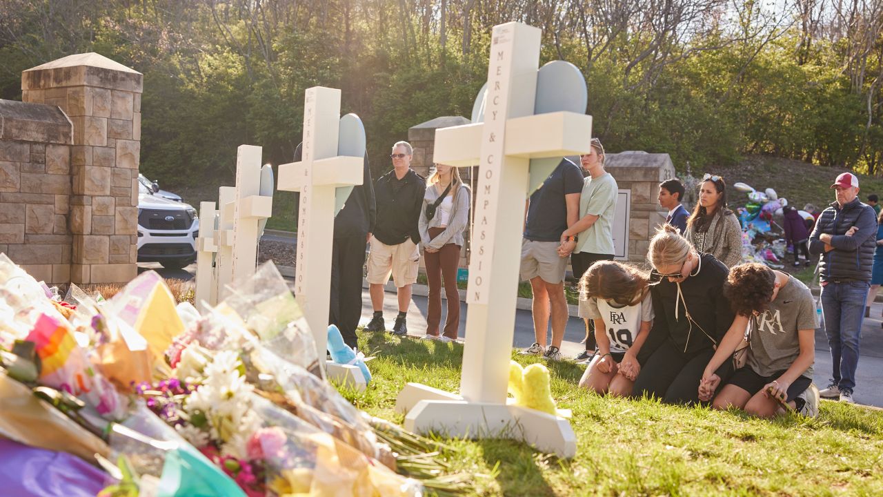 People gather at a makeshift memorial at The Covenant School a day after the mass shooting.