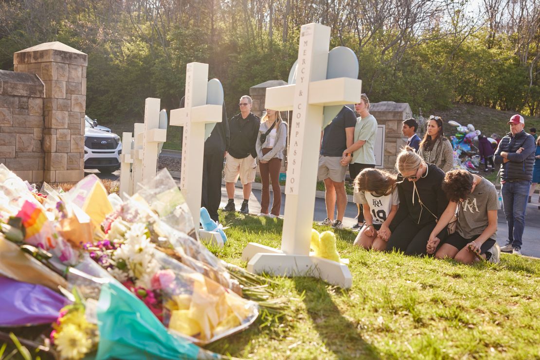 People gather at a makeshift memorial at The Covenant School a day after the mass shooting.