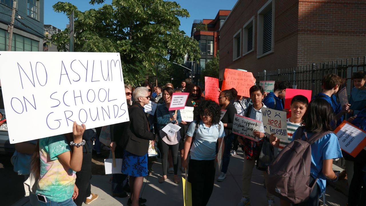 Students and parents from Public School MS 577 in New York City protest housing migrants at the school gym.