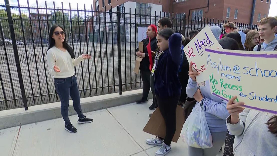 An organizer speaks to a group of protesters early Wednesday morning at PS 17 in Brooklyn.