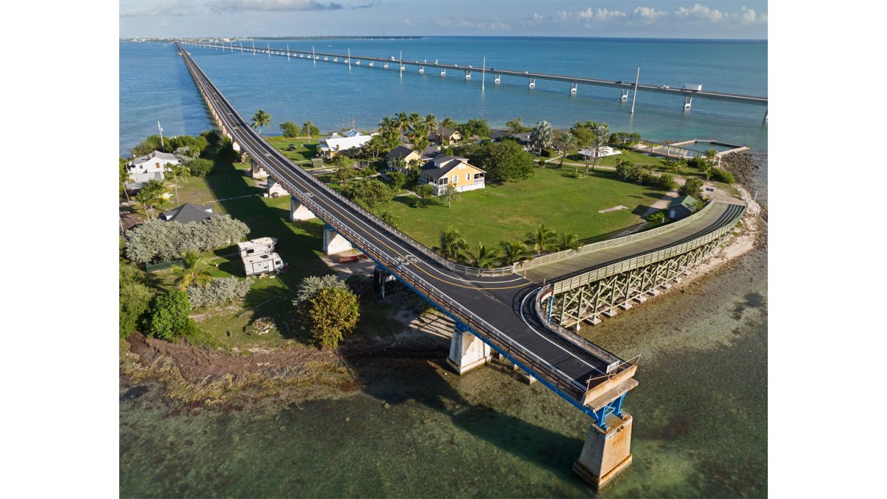 This Monday, Jan. 10, 2022, drone aerial photo shows the Old Seven Mile Bridge ready for its Wednesday, Jan. 12, 2022, reopening to pedestrians, bicyclists, anglers and visitors to Pigeon Key (island shown in photo). The old bridge originally was part of Henry Flagler's Florida Keys Over-Sea Railroad that was completed in 1912. The railroad ceased operations in 1935 and was converted into a highway that opened in 1938. In 1982 construction was completed on a new Seven Mile Bridge, behind, that continues to carry motor vehicles between the South Florida mainland throughout the Keys to Key West. FOR EDITORIAL USE ONLY (Andy Newman/Florida Keys News Bureau/HO)