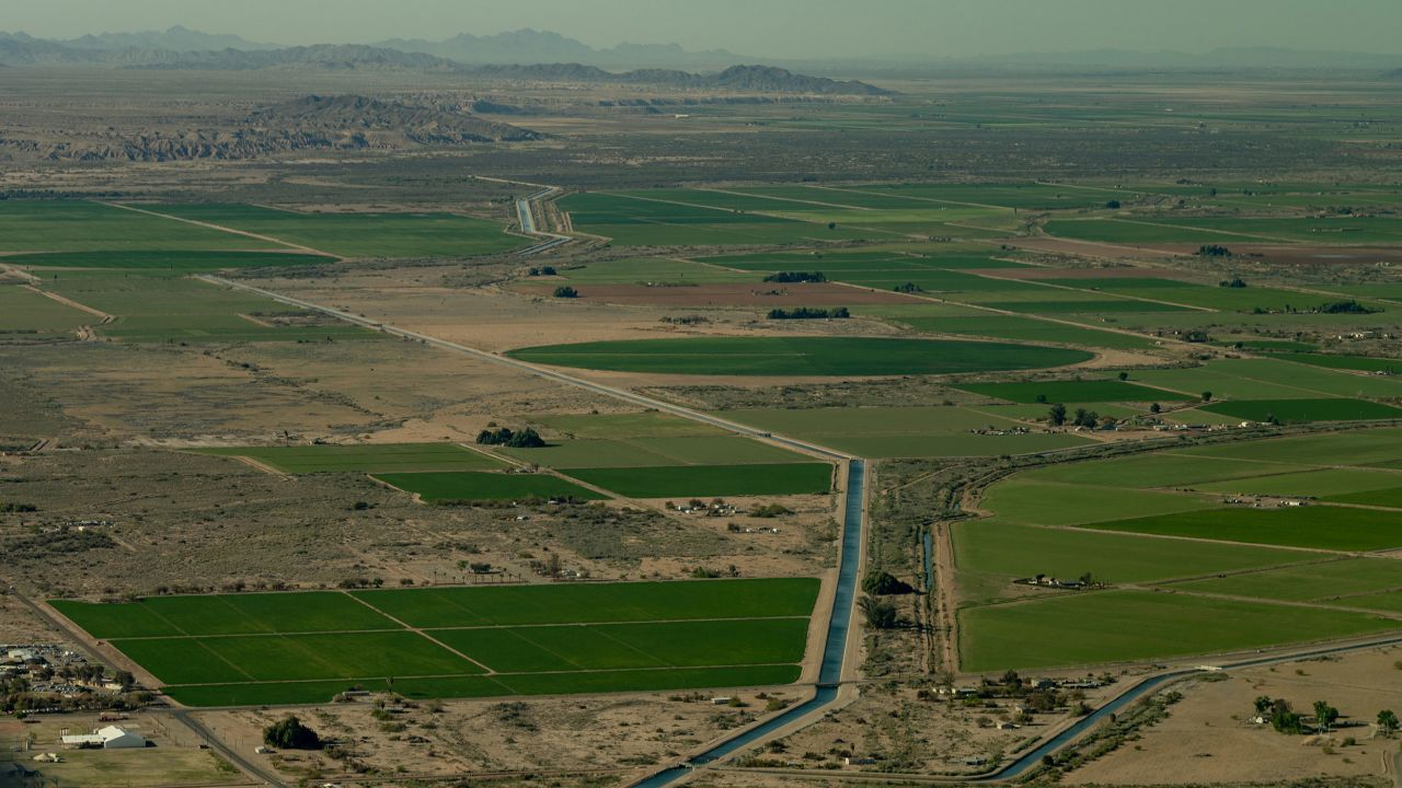 A canal runs through farm land in near the California-Arizona border on April 4, 2023.