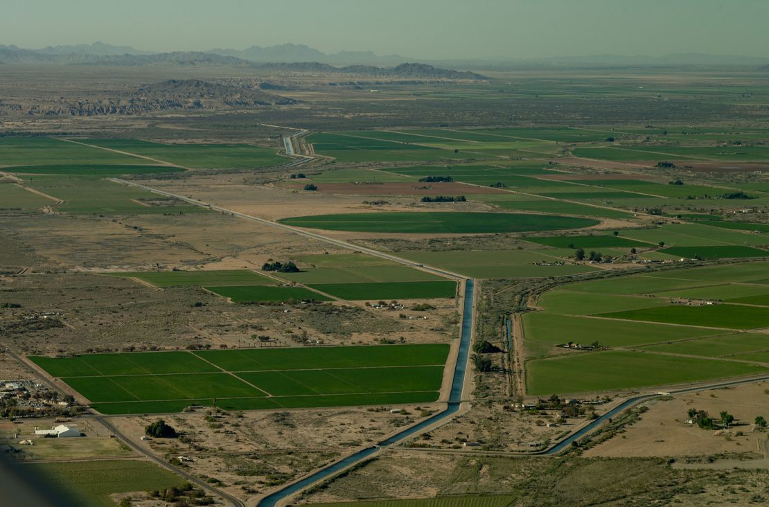 A canal runs through farm land in near the California-Arizona border on April 4, 2023.