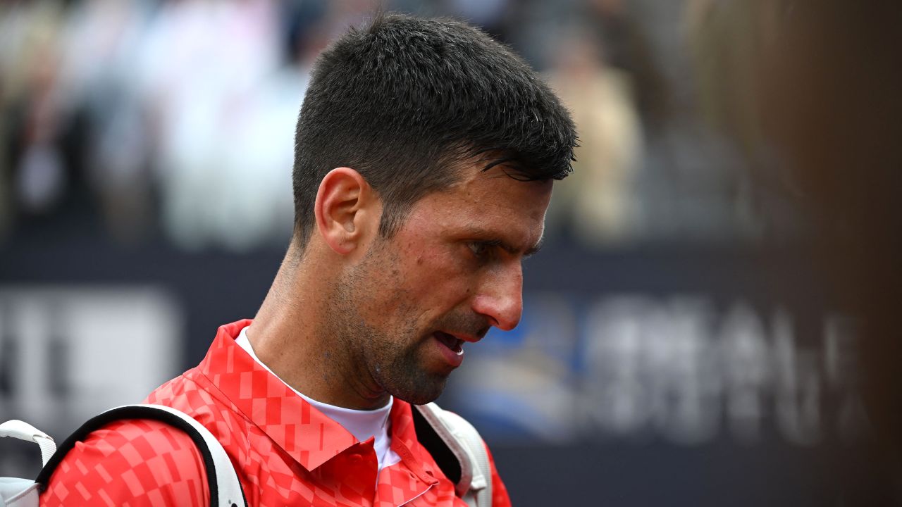 Novak Djokovic leaves the court after losing his quarterfinal match against Denmark's Holger Rune.