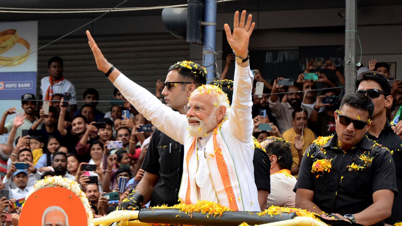 Indian Prime Minister Narendra Modi waves to the crowd during campaigning for state elections in Bengaluru, Karnataka, on May 7.