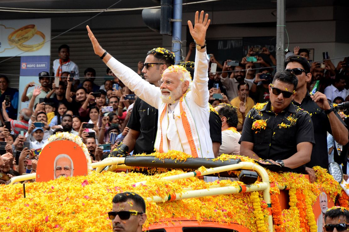 Indian Prime Minister Narendra Modi waves to the crowd during campaigning for state elections in Bengaluru, Karnataka, on May 7. 