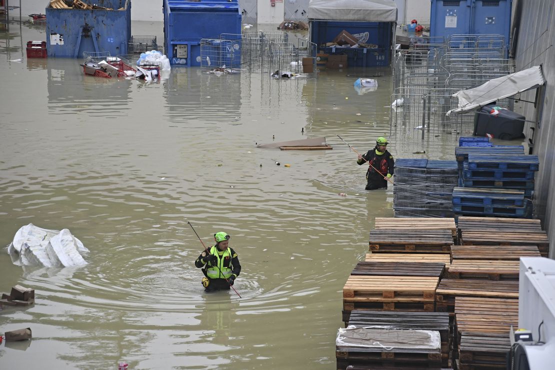 Speleological alpine rescuers search for missing persons in a flooded area near a supermarket in the city of Cesena on Wednesday. 