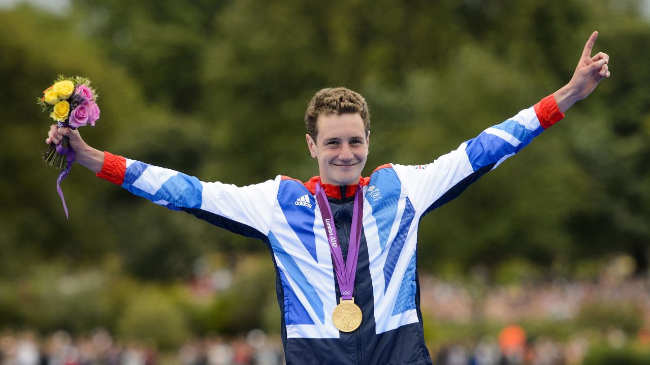 Alistair Brownlee celebrates on the podium after winning gold in the men's triathlon event at the London 2012 Olympic Games.