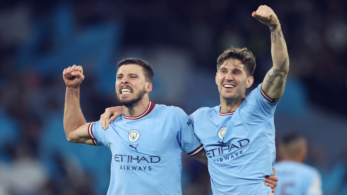 Rúben Dias and John Stones celebrate beating Real Madrid on Wednesday.