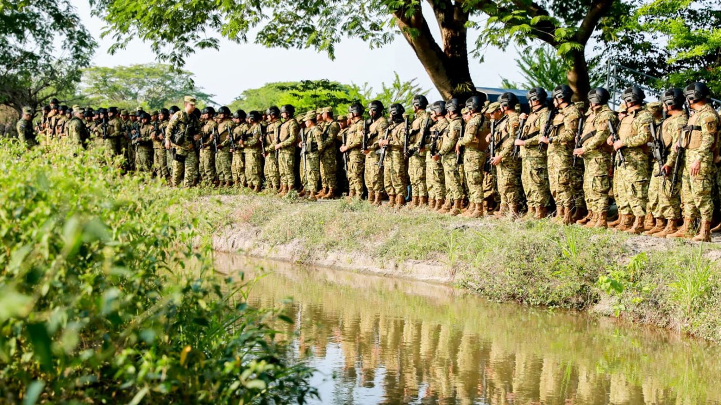 Salvadoran soldiers stand by a road of Nueva Concepcion after El Salvador's President Nayib Bukele announced the deployment of more than 5,000 security forces to the area, in this handout distributed to Reuters, May 17, 2023. 