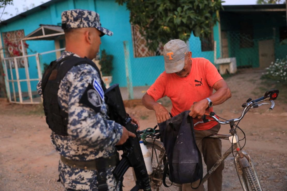 A police officer stops a man in Nueva Concepcion after Bukele announced the deployment of security forces to the area in May 17, 2023. 