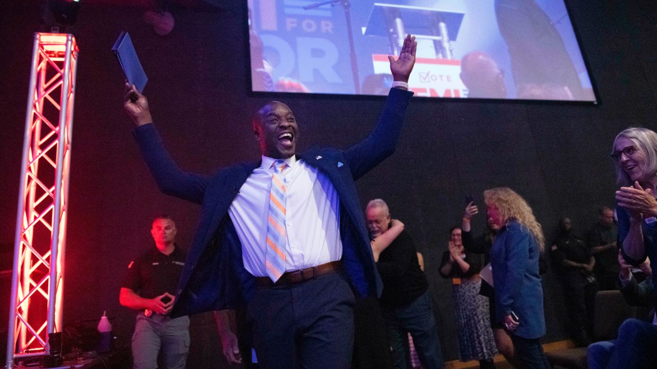 Colorado Springs mayoral candidate Yemi Mobolade cheers as he runs onto the stage to give a speech, Tuesday, May 16, 2023, during an election watch party at the COS City Hub in Colorado Springs, Colo.