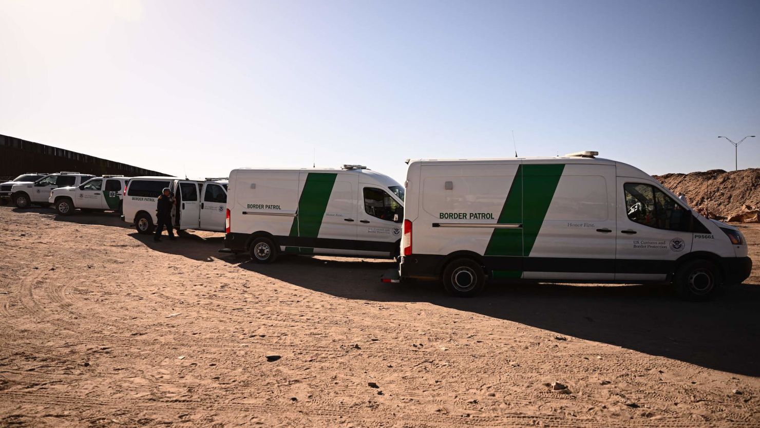 Migrants board Border Patrol vans along the border wall in El Paso, Texas, on May 11. 