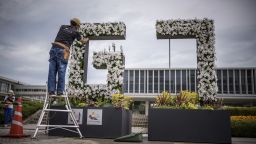 18 May 2023, Japan, Hiroshima: A gardener works on a G7 logo made of flowers with Genbaku Dome in the background in Hiroshima Peace Memorial Park. The G7 summit in Hiroshima will be held May 19-21. The "Group of Seven" (G7) is an informal alliance of leading democratic industrialized nations of members Canada, France, Germany, Italy, Japan, the United Kingdom and the United States. Photo by: Michael Kappeler/picture-alliance/dpa/AP Images