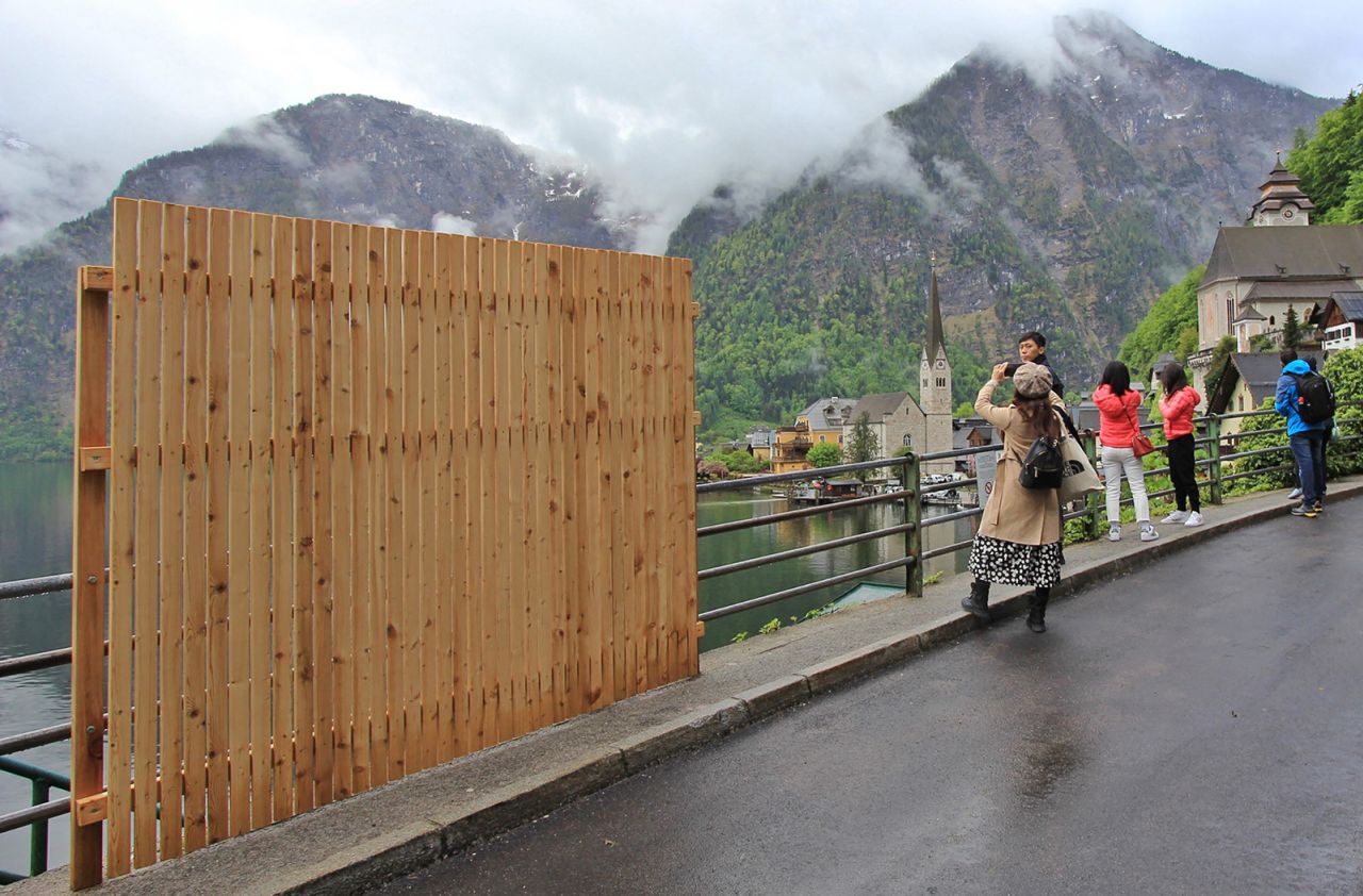 <strong>View? What view?:</strong> The Austrian village of Hallstatt, pictured here on May 15, temporarily put up a wooden fence to deter the throngs of tourists who gather at this spot. 