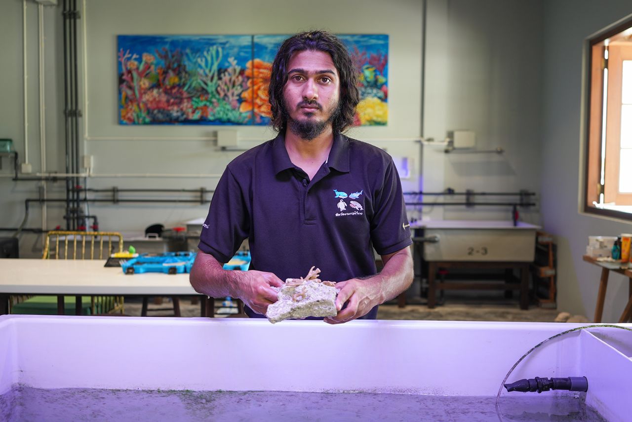 Ali Shaamy, research assistant in the Marine Discover Centre, demonstrates the coral propagation process.