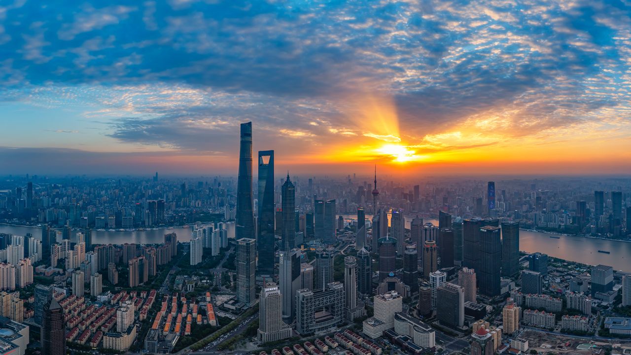 The sun sets over Shanghai's Lujiazui Financial District on May 8, 2023