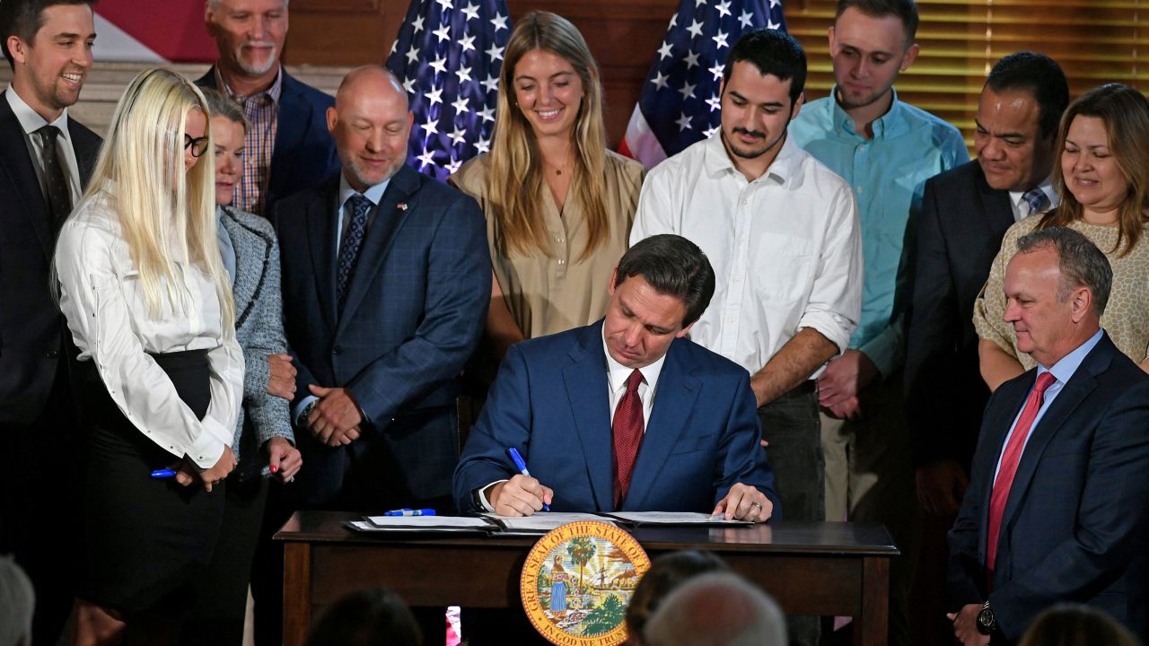 Florida Gov. Ron DeSantis signs three bills into legislation, including one that bans tax dollars from being used in state colleges for diversity, equity and inclusion programs, at New College of Florida on May 15, 2023.