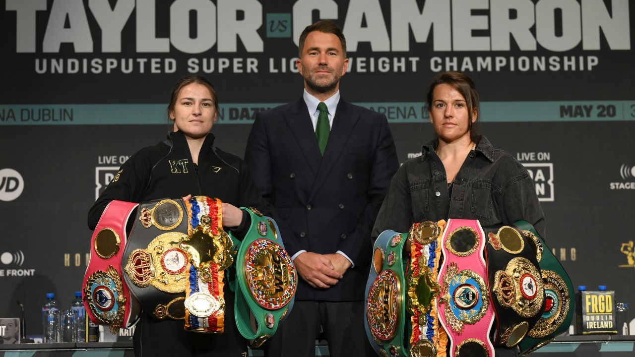 Katie Taylor (left) and Chantelle Cameron (right) pose with promoter Eddie Hearn during a press conference.