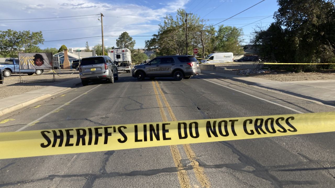 Law enforcement officers cordon off roads following the neighborhood mass shooting.