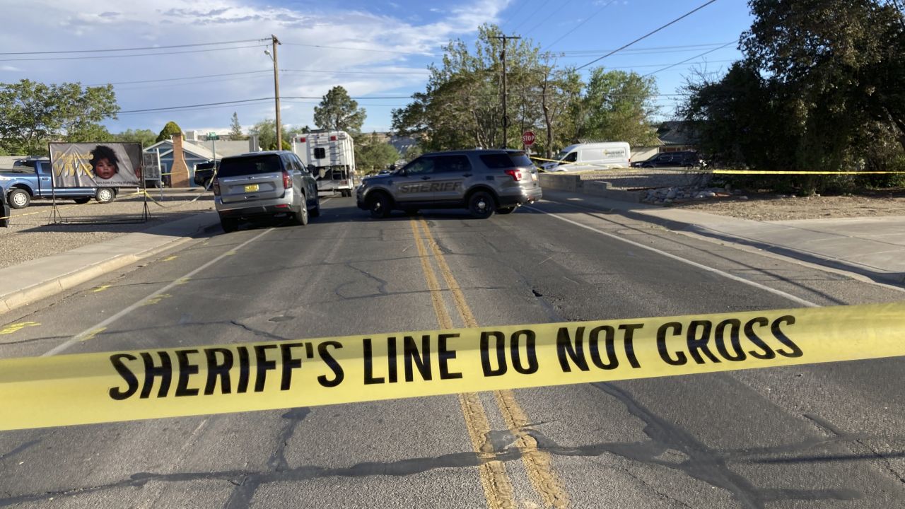 Law enforcement officers cordon off roads following the neighborhood mass shooting.