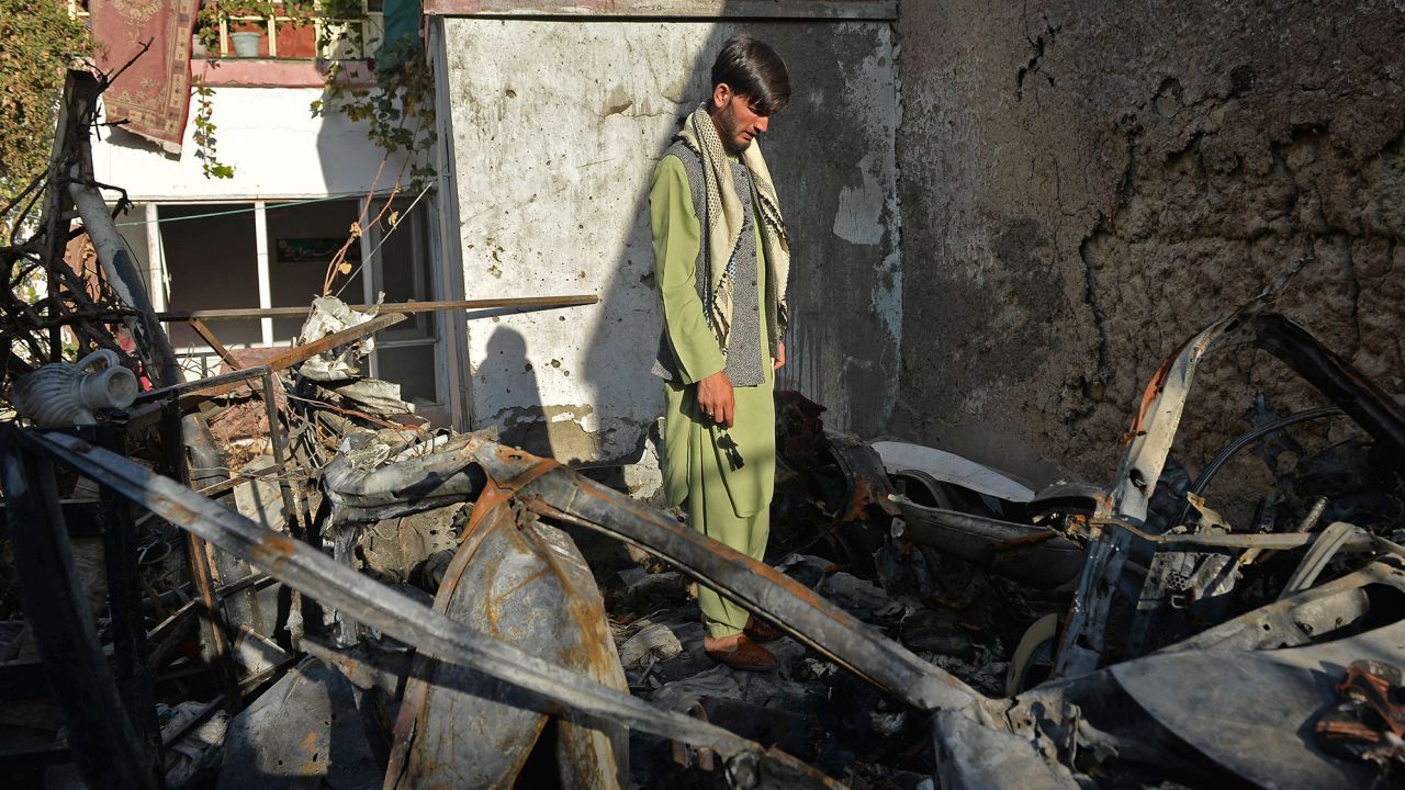 A man stands amid the debris of a US drone strike intended for an ISIS-K terrorist, which instead killed an aid worker and his family on August 29, 2021.