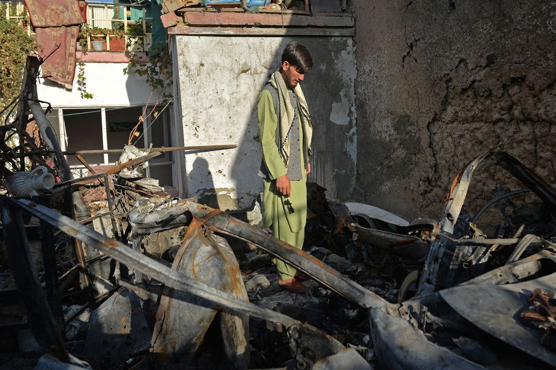 A man stands amid the debris of a US drone strike intended for an ISIS-K terrorist, which instead killed an aid worker and his family on August 29, 2021.