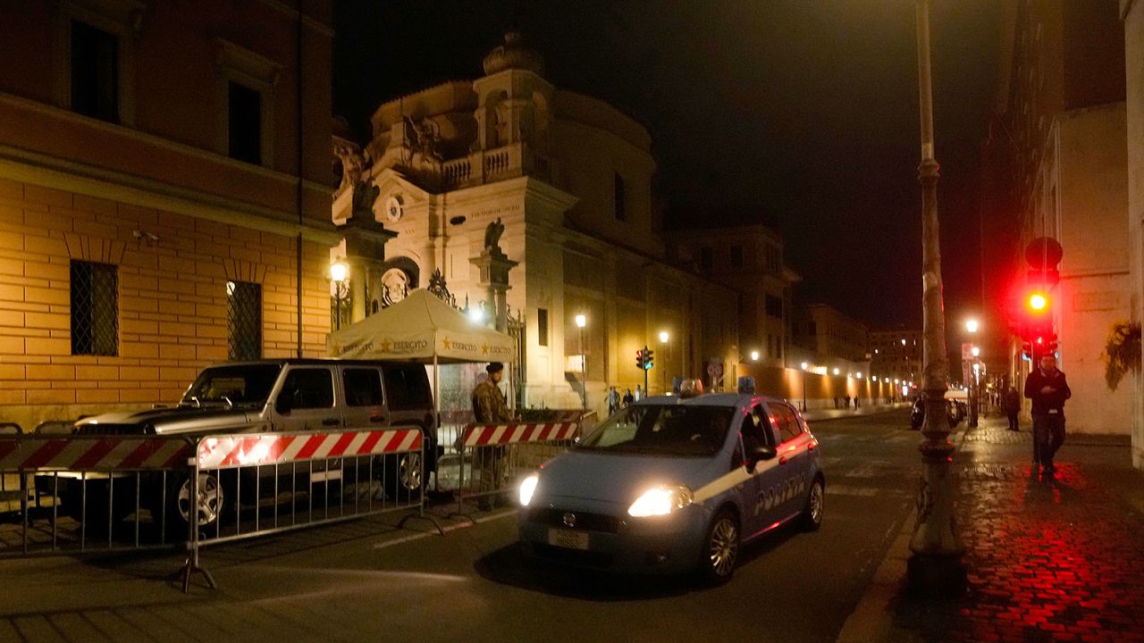 An Italian police car passes in front of Santa Anna gate at the Vatican, late Thursday, May 18, 2023.