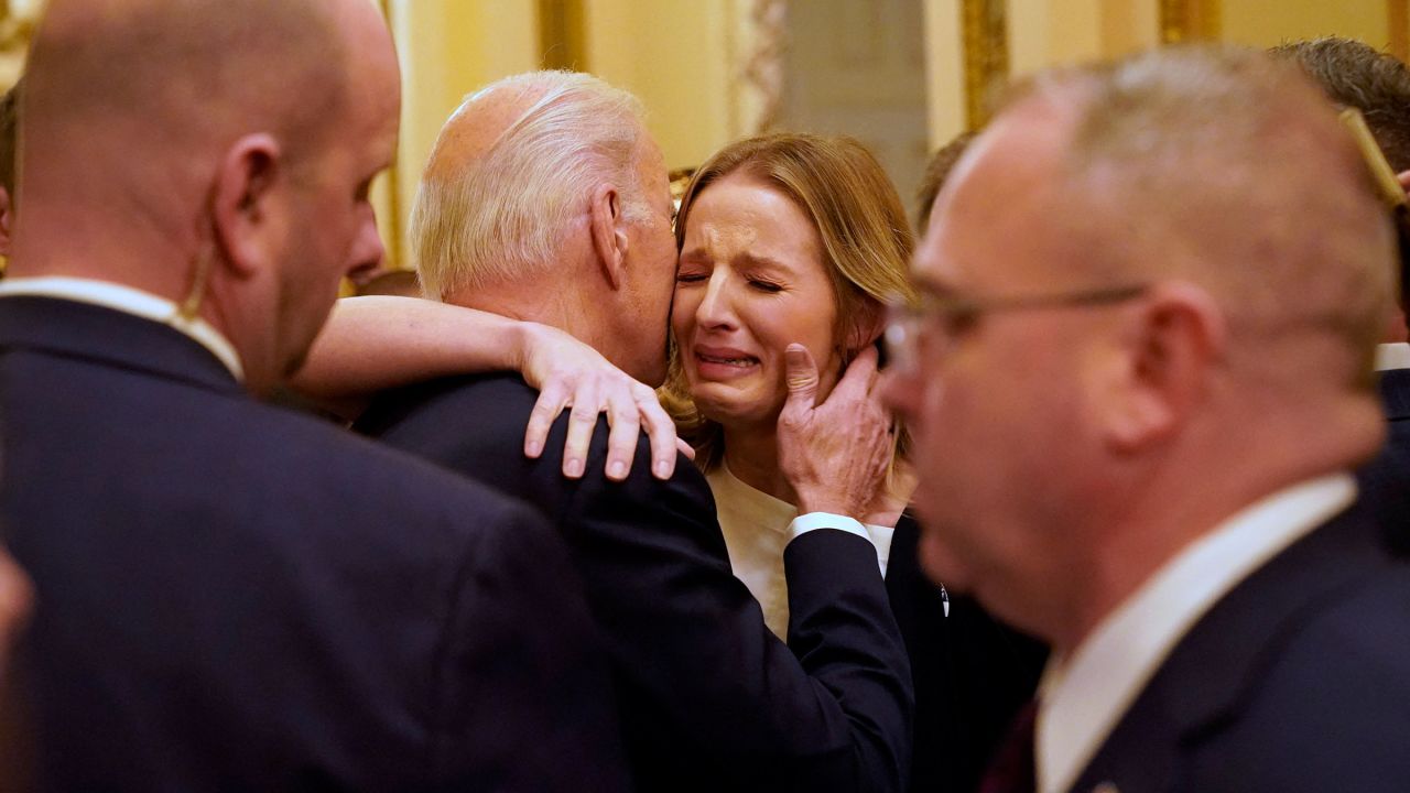 President Joe Biden hugs Brittany Alkonis, the wife of Lt. Ridge Alkonis serving prison sentence in Japan, after the State of the Union address in the House Chamber of the Capitol in Washington, DC, on February 7.