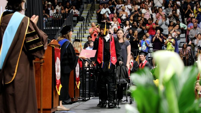 NextImg:Weeks before graduating high school, he was shot and paralyzed. 7 years later, he walked across the stage to accept his college degree | CNN