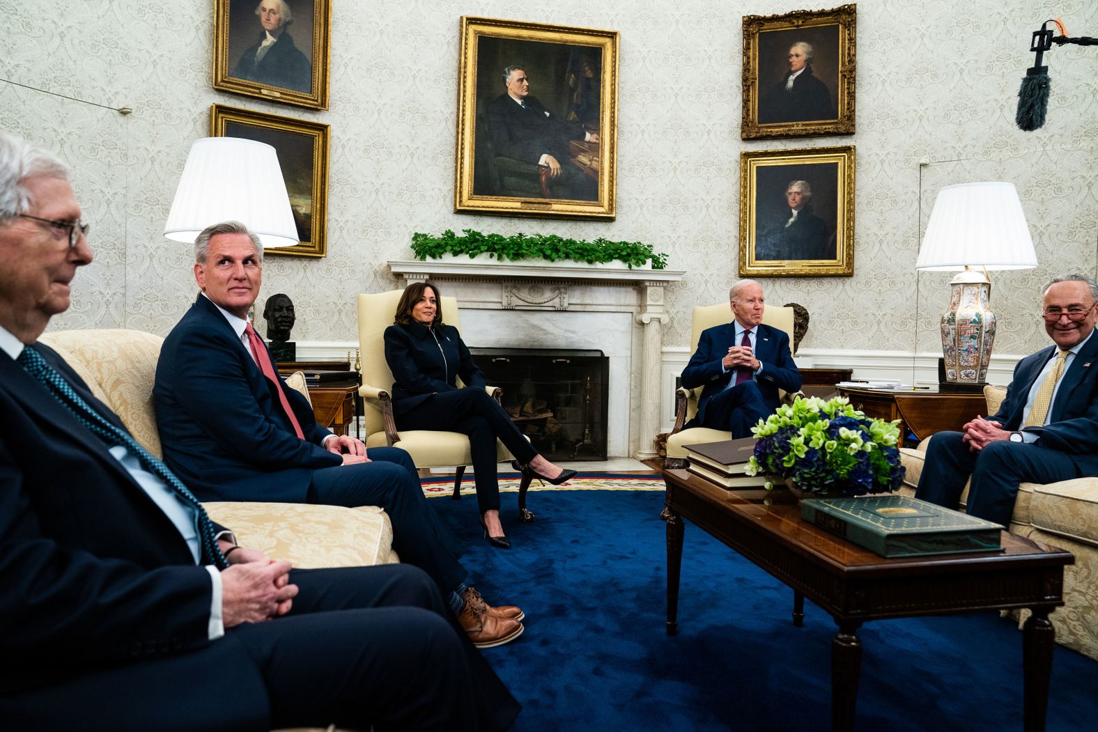 US President Joe Biden, second from right, and Vice President Kamala Harris <a href="index.php?page=&url=https%3A%2F%2Fwww.cnn.com%2F2023%2F05%2F16%2Fpolitics%2Fbiden-kevin-mccarthy-debt-default-negotiations%2Findex.html" target="_blank">meet with congressional leaders</a> in the White House Oval Office on Tuesday, May 16, to talk about a deal to raise the nation's borrowing limit and avoid a historic default. Joining Biden and Harris, from left, are Senate Minority Leader Mitch McConnell, House Speaker Kevin McCarthy and Senate Majority Leader Chuck Schumer.