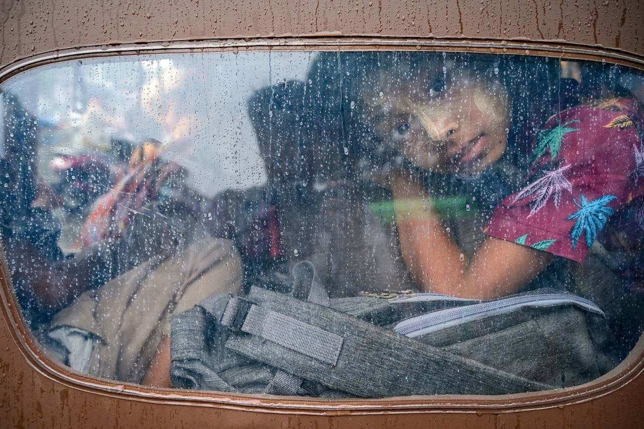 A girl looks out from a rickshaw while evacuating Sittwe, Myanmar, on Saturday, May 13 — a day before Cyclone Mocha made landfall. 