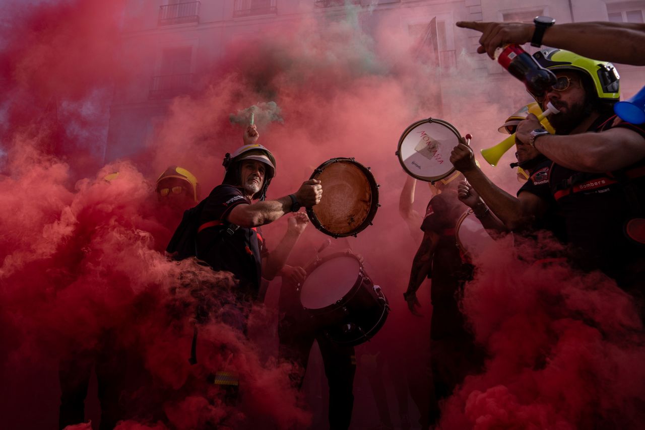 Firefighters play drums and chant slogans during a demonstration in Madrid on Tuesday, May 18. They were calling for a national, legal framework for fire services that would regulate employment and working conditions.