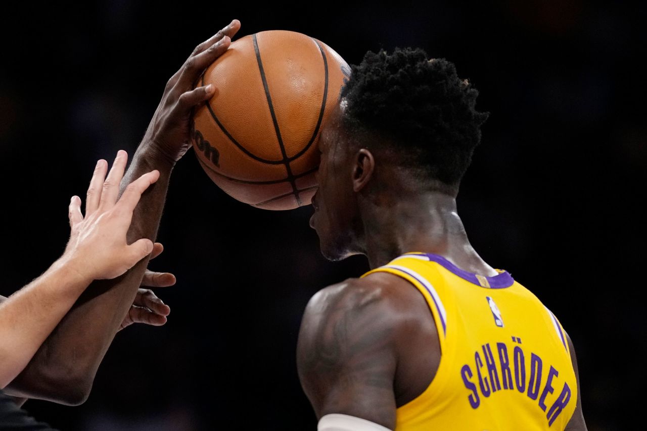 Los Angeles Lakers guard Dennis Schröder gets a ball shoved in his face by Golden State's Draymond Green during an NBA playoff game on Friday, May 12. The Lakers eliminated Golden State, last season's champions.