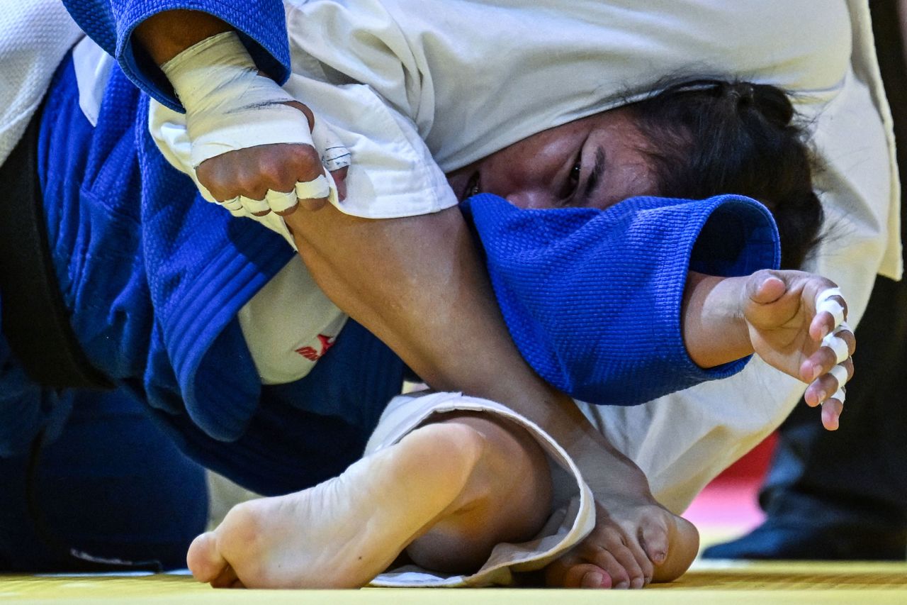 Vietnam's Hoang Thi Tinh, in blue, competes against Thailand's Wanwisa Muenjit during a judo match at the Southeast Asian Games on Monday, May 15. Hoang defeated Muenjit to win gold in their weight class.