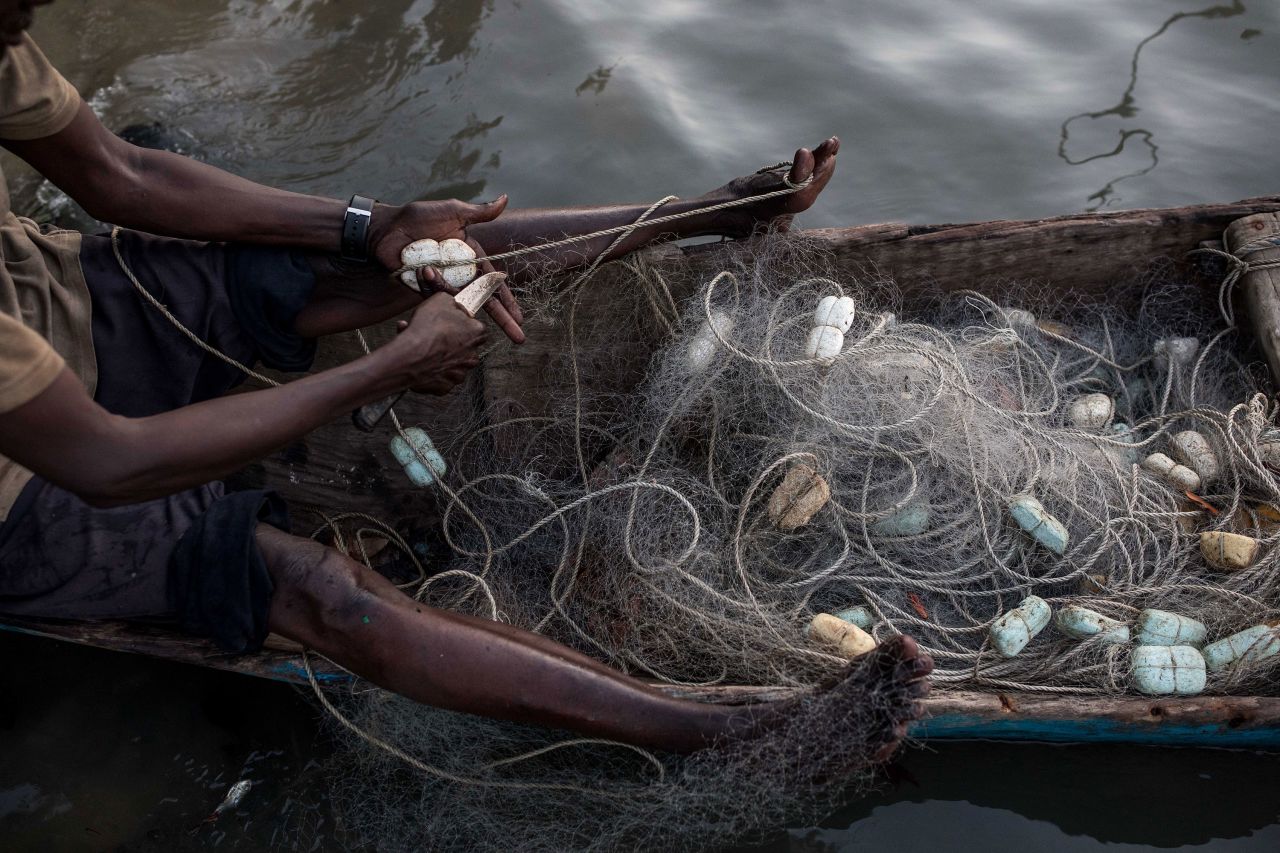 A fisherman repairs a net along the Casamance River in Ziguinchor, Senegal, on Tuesday, May 16.