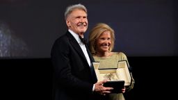 US actor Harrison Ford poses on stage with French Director of the Cannes film festival Iris Knobloch after he was awarded with an Honourary Palme d'or prior to the screening of the film "Indiana Jones and the Dial of Destiny" during the 76th edition of the Cannes Film Festival in Cannes, southern France, on May 18, 2023. (Photo by Valery HACHE / AFP) (Photo by VALERY HACHE/AFP via Getty Images)