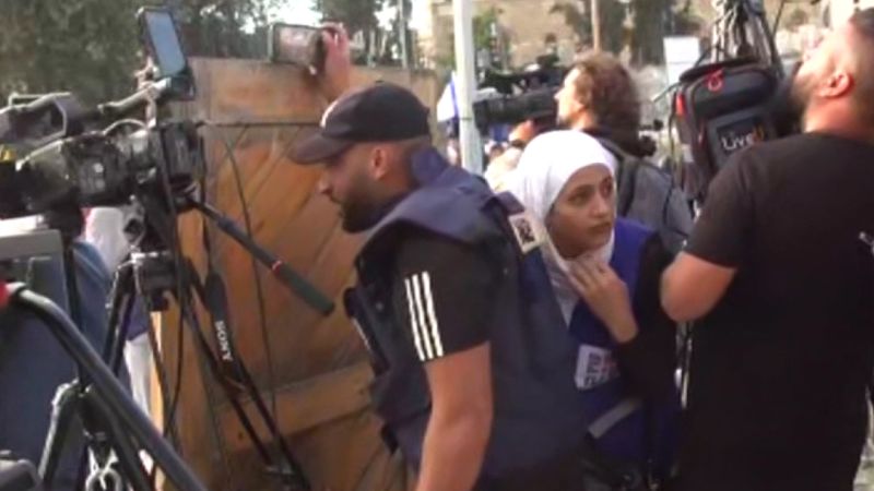 NextImg:Watch: Journalists forced to take cover while reporting at Jerusalem Day march | CNN