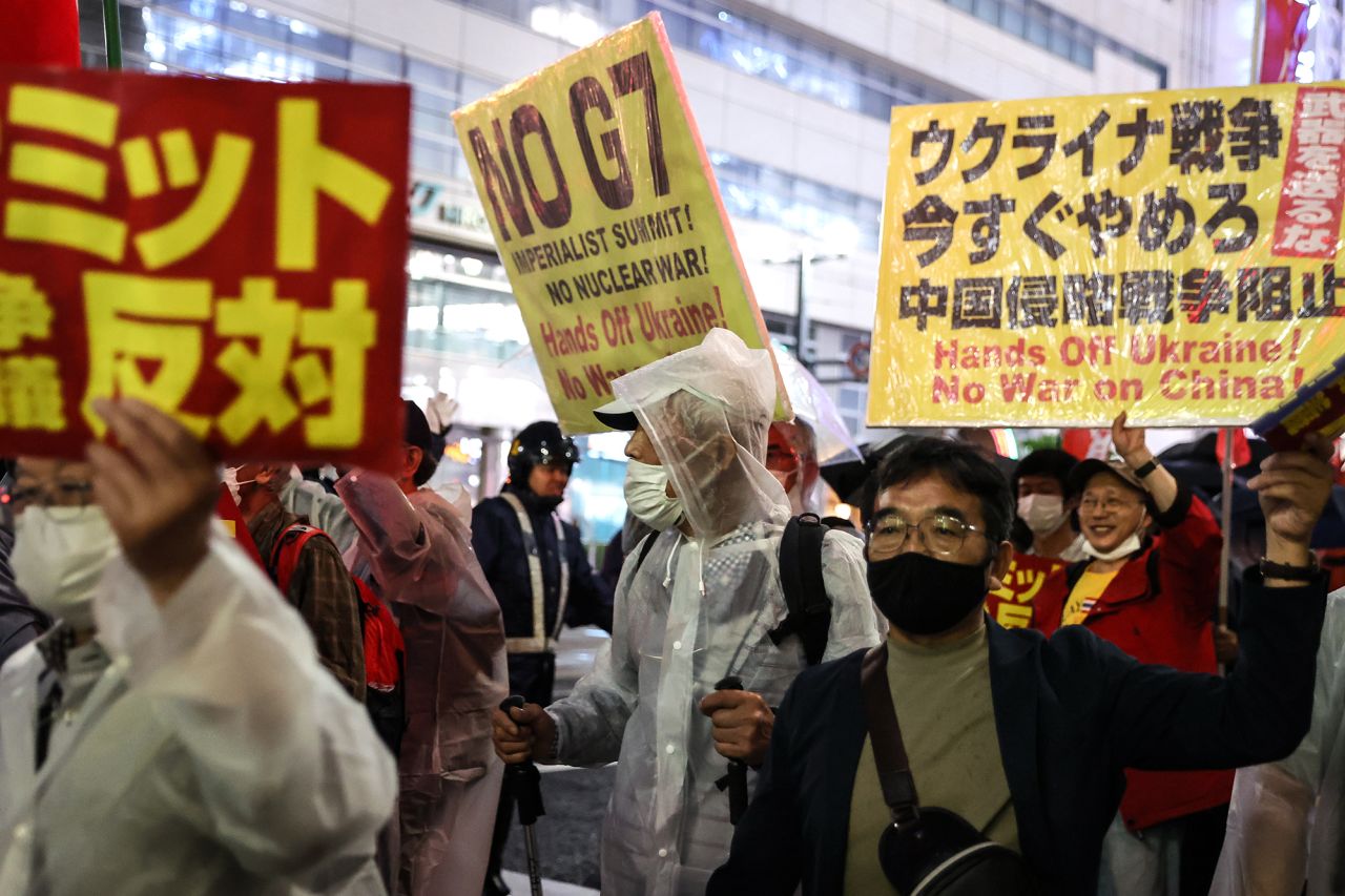 People hold signs and chant slogans during the march to protest against G7 Summit in Hiroshima on Thursday, May 18.