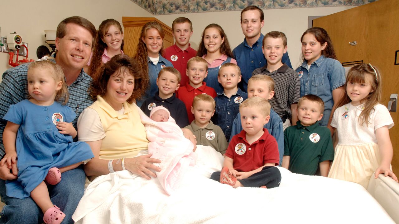 Michelle Duggar, left, is surrounded by her children and husband Jim Bob, second from left, after the birth of her 17th child in Rogers, Arkansas in 2007.