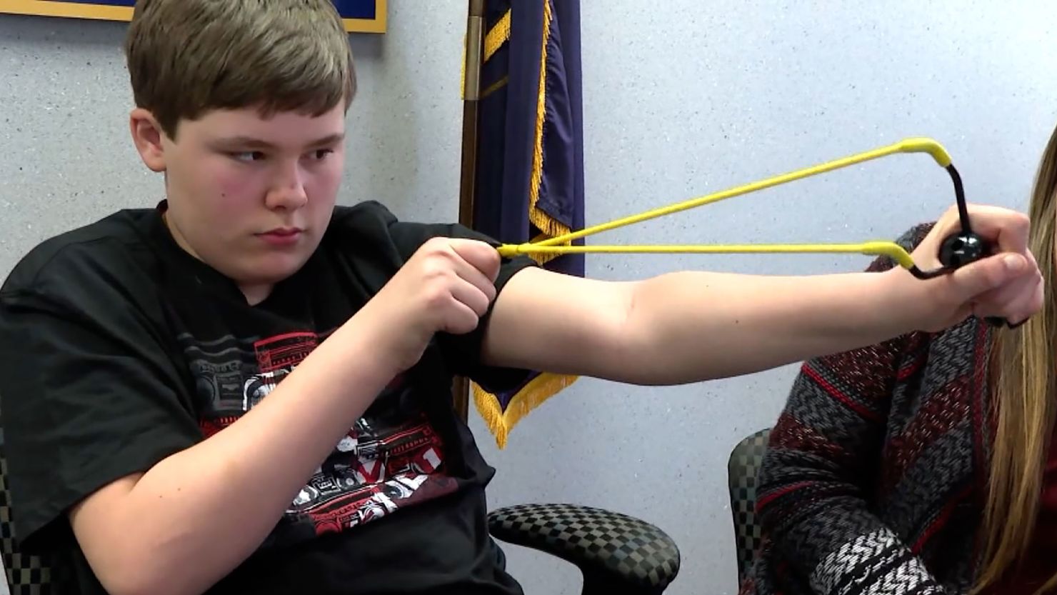 Owen Burns pulls back the slingshot he used to ward off a kidnapper from his 8-year-old sister