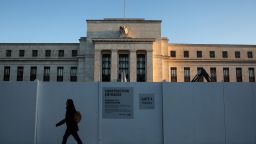A pedestrian walks past the Federal Reserve Headquarters on March 21, 2023 in Washington, DC.