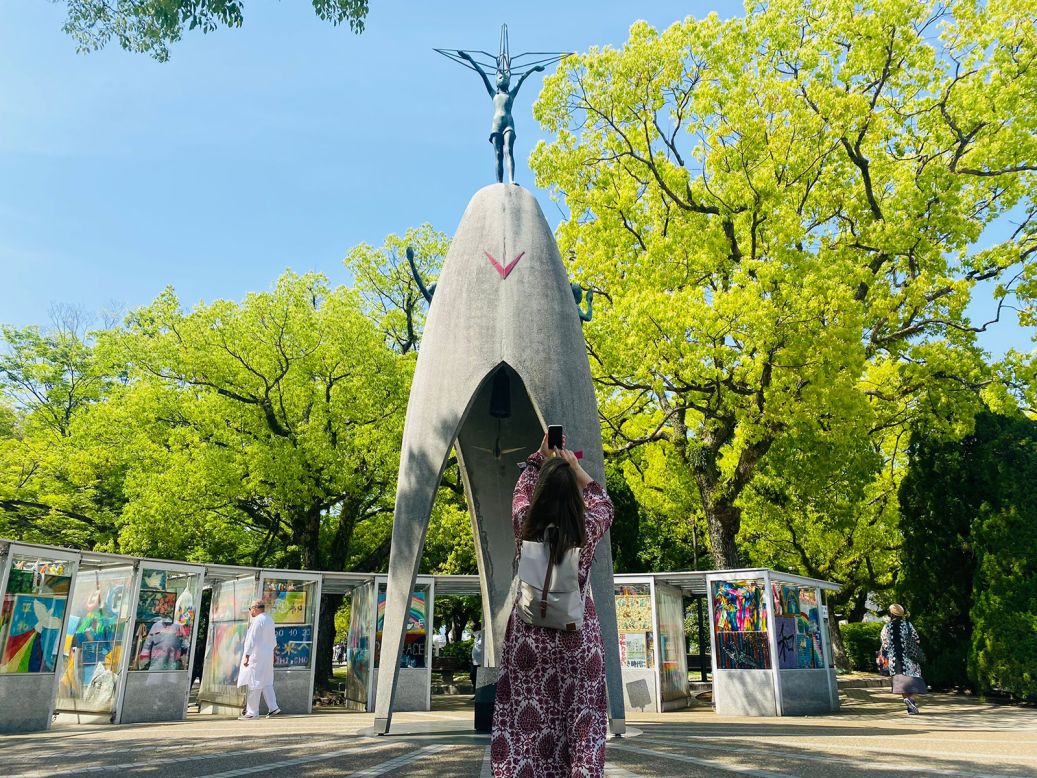 <strong>Children's Peace Monument: </strong>A woman takes a photograph of the Children's Peace Monument in Hiroshima's Peace Memorial Park.